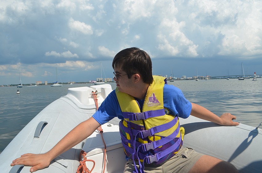 Andrew Feduccia, 13, watches the sailors out on the bay during a Manasota BUDS book club gathering on Sept. 24.