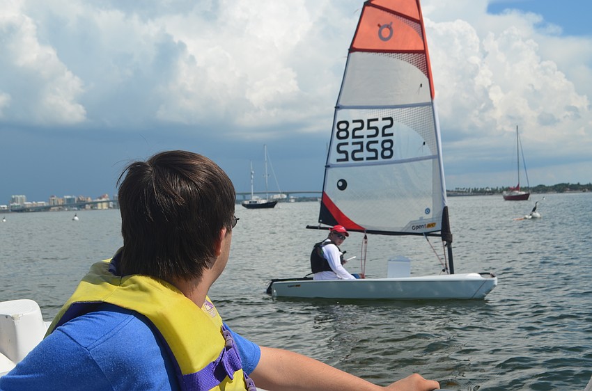 Andrew Feduccia, 13, watches the sailors out on the bay during a Manasota BUDS book club gathering on Sept. 24.
