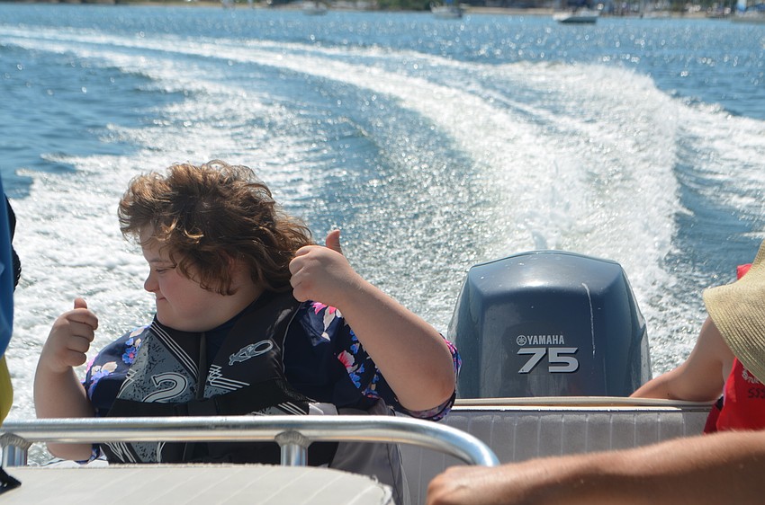 Madison Underwood, 14, gives two thumbs up during her boat ride around the bay.
