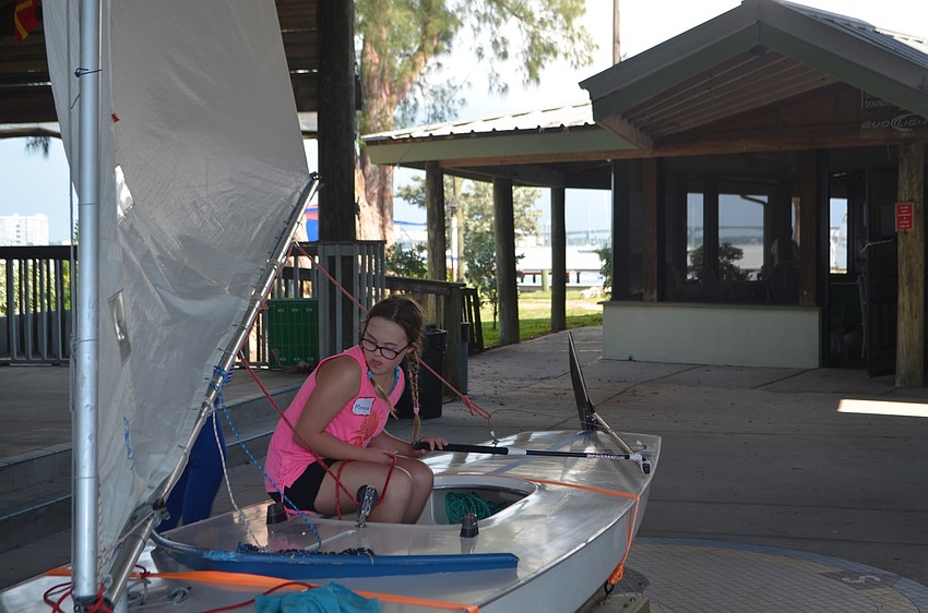 Morgan Summers learns how to steer a sailboat during a Manasota BUDS book club gathering on Sept. 24.