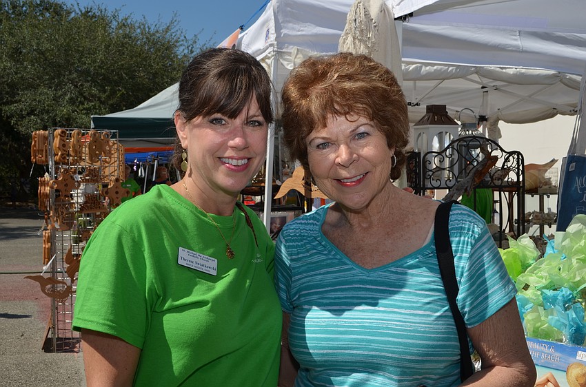 Therese and Mary Swaitkowski peruse the arts and crafts booths during the festival Saturday afternoon.