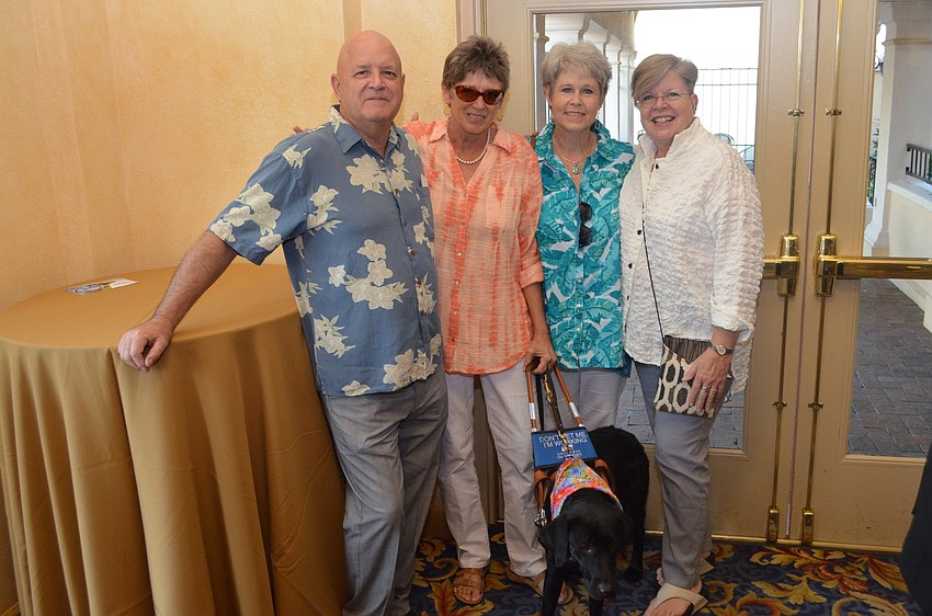 Mark Runnals, Cheryl Kinderknecht, Lin Oakerson and Suzanne Reynolds with Kennesaw, a 3-year-old graduate of the Southeastern Guide Dogs program.