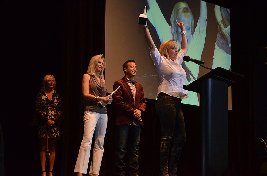 Susan Jones reenacts how she responded to the news that there was one dog sculpture left without a sponsor. She, with the Jones Family Foundation, sponsored said dog: Best in Show winner Robert Sterling Jones “Bob” created by artist Lynn Snyder-Hinds.