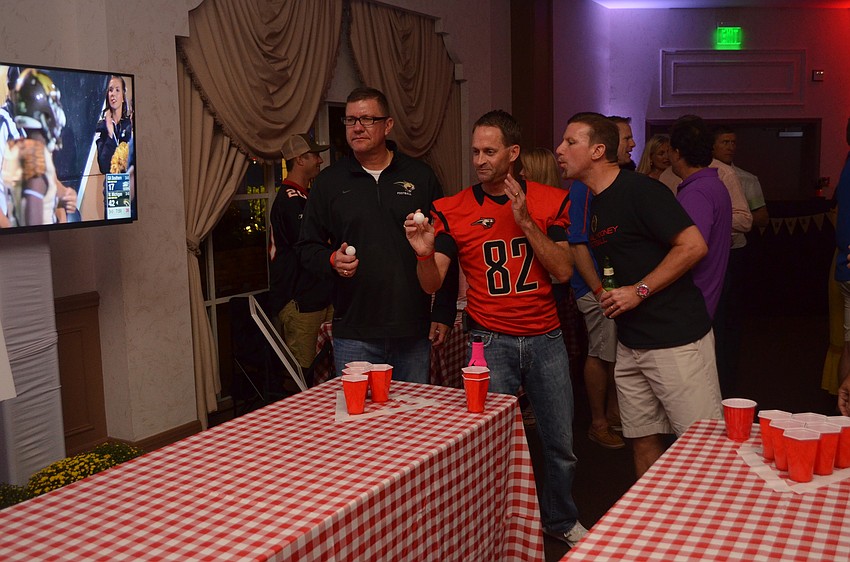 Patrick Del Medico tries to distract Dave Jackson as he plays beer pong with Caleb Swink.