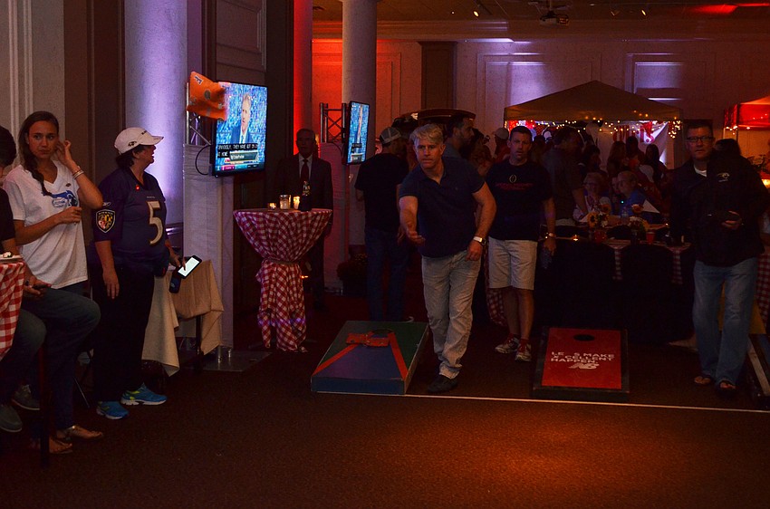 Matt Beall tosses his bag in hopes of scoring during a game of cornhole.