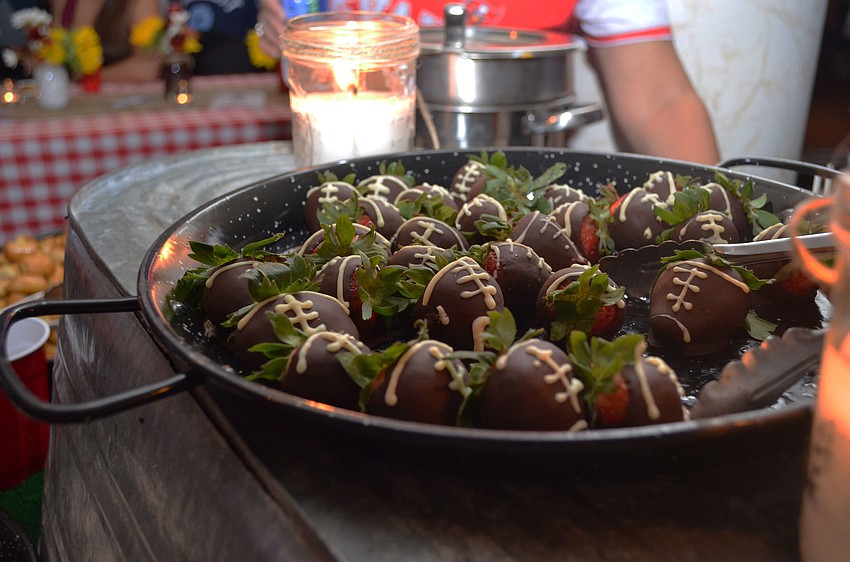 Guests munched on snacks such as chocolate-covered strawberries decorated to look like footballs.
