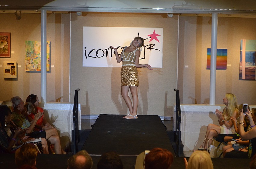 Amy Schineller, 13, strikes a pose at the end of the runway after showing off her creation, “Naughtical.” Schineller made the ensemble using Ancient Goliath grouper scales and Found Rope.