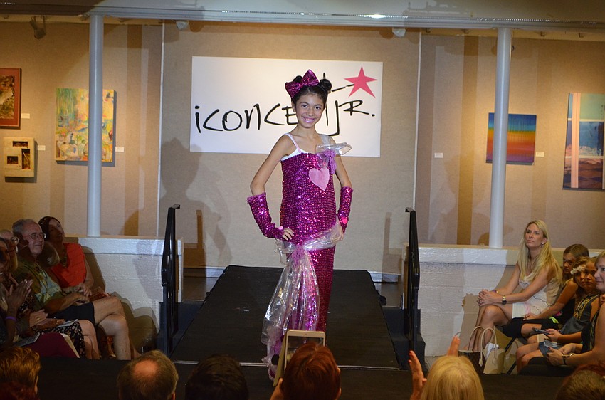 Ava Abreu,11, sports her design, “Ava Universe,” which she created using pink-sequined fabric, clear plastic bags and thread.