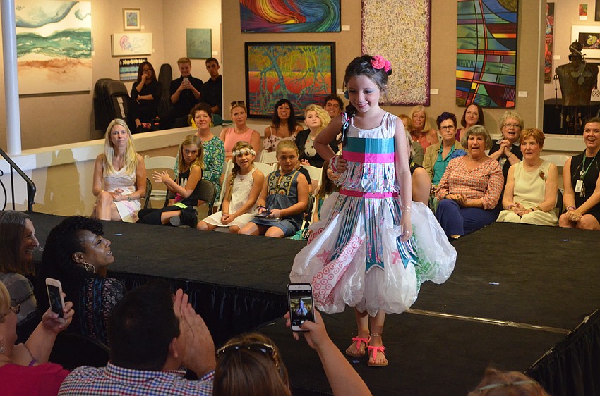 Madison Anderson, 8, models her piece, “Water Life.” Anderson used cardboard, plastic bags and rope to create her garment, which she says was inspired by her desire to help the sea creatures harmed by litter.