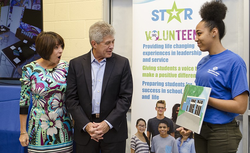 Debbie and Tom Shapiro receive a painting from Boys & Girls Club member Jasmine Jones to commemorate their contributions to the Career Resource Center.
