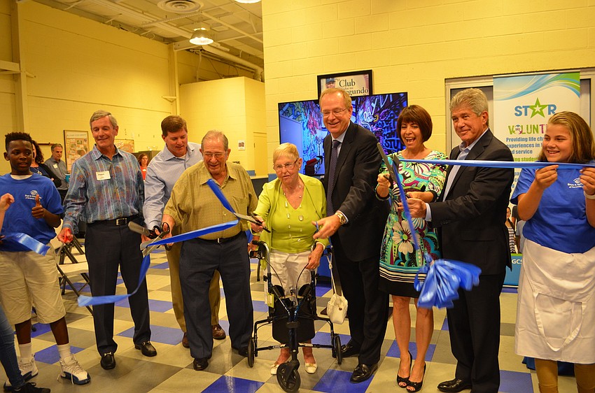 Boys & Girls Club of America President and CEO Jim Clark, center, helps cut the ribbon for the Tom and Debbie Shapiro Career Resource Center Thursday, Sept. 29.