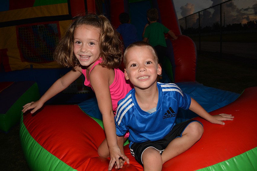 Lily and Hunter Bertrand, students at McNeal Elementary School, played on the inflatable slide before the movie started.