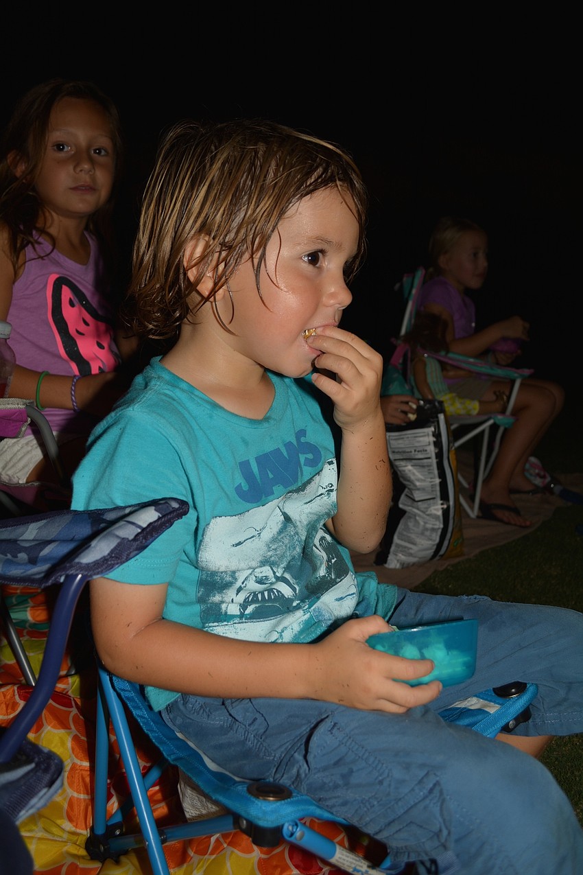 T.J. Amato, 4, of Del Tierra, snacks on popcorn with his friends as the movie starts.
