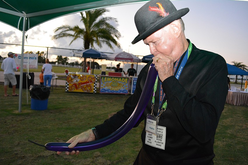 Peridia's Stevie Dee blows up balloon swords and animals for children and even sneaks in a few magic tricks.