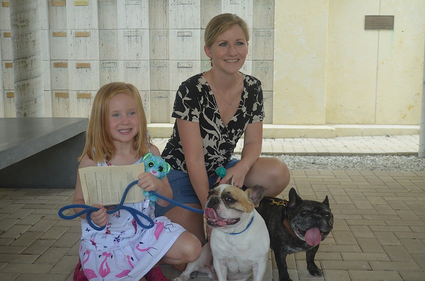 Megan, 5, and Beth Murdock with their dogs, Newton and Dewey, both french bulldogs