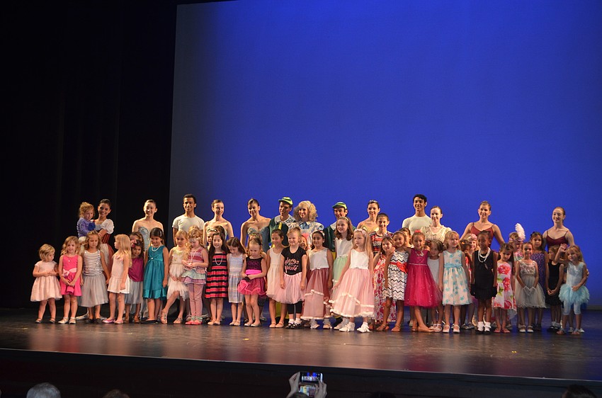 Audience members and future ballerinas pose with Alice, Tweedle Dee and Tweedle Dum before having tea at the second annual Tea & Tutus on Oct 1.
