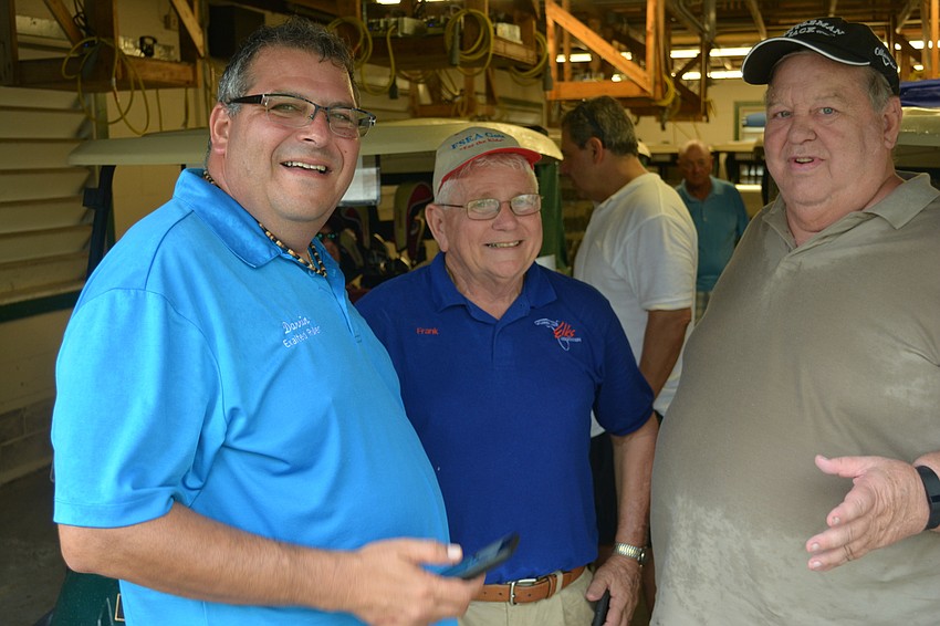 Elks Exalted Ruler Darrin Simone and fellow Elks Frank Malatesta  and Jack Ogren try to dry off in the cart barn after rain and lightning halted the tourney after nine holes.