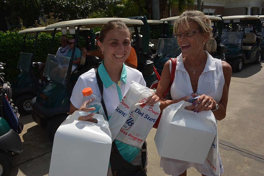 Bobbie Mauro and Diane Belcher of Bradenton show off their box lunches before heading on the course.