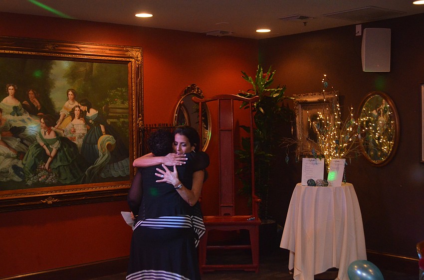 Rachel Saltzberg hugs Wendy Katz after Katz’s speech about Saltzberg.