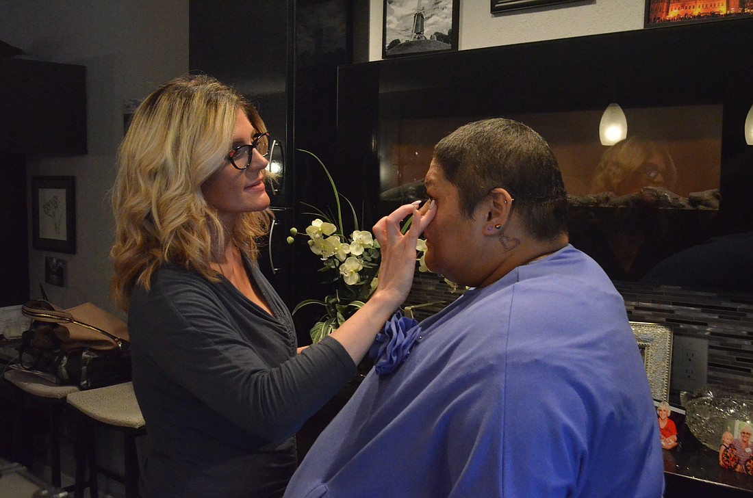 Dawn Patterson, Chanel counter makeup artist at Saks Fifth Avenue, prepares breast cancer patient Melissa Clauson for her photoshoot. Clauson heard about the Wrapped in Love call for patient models from her advocate at Sarasota Memorial Hospital.