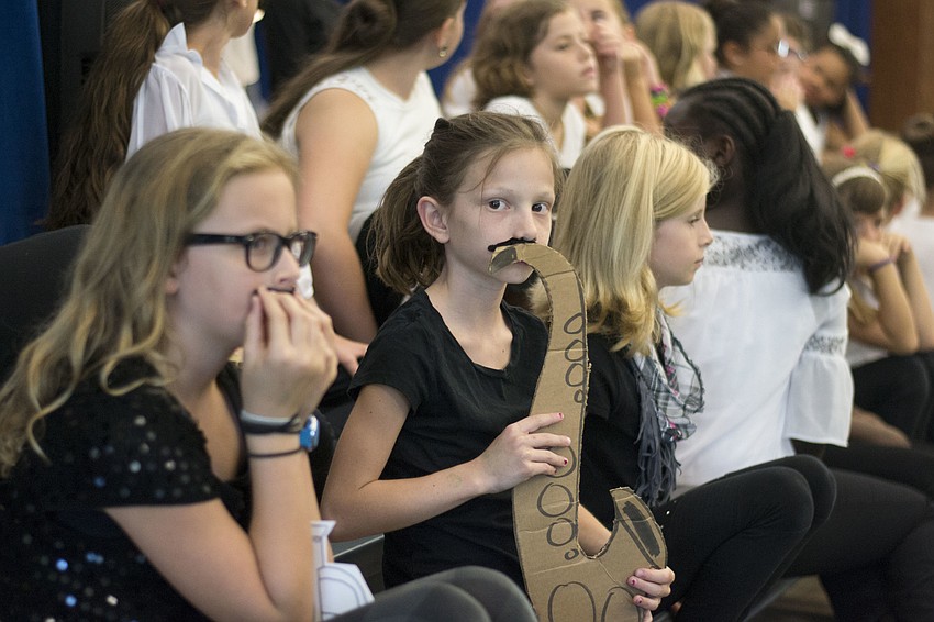 Nolan Welch with her cardboard saxophone.