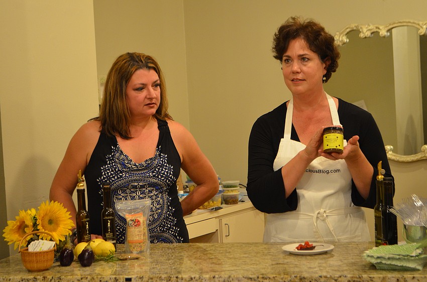 Paulette Callender listens as Chef Nicole Coudal, author of MyDeliciousBlog.com, explains how the caramelized onion jam enhances a dish.