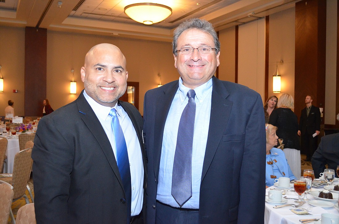 Your Observer Photo John Acevedo and Dr. Stephen Nicholas of the Community Aids Network.