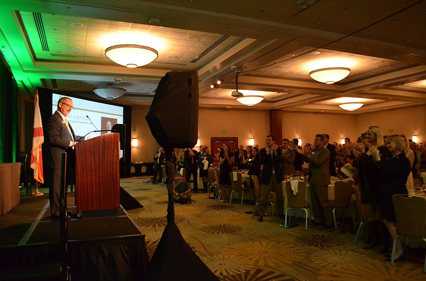 Guests give a standing ovation to outgoing Sarasota Chamber President and CEO Steve Queior.