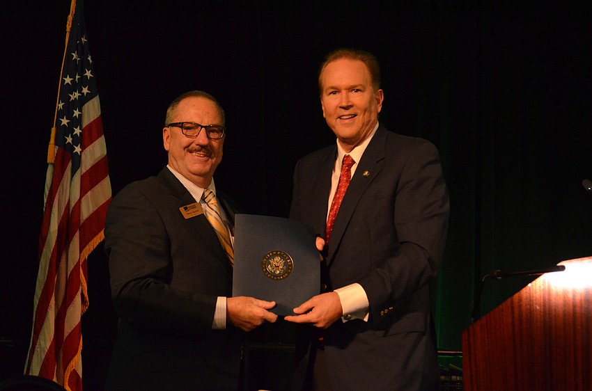 Outgoing Sarasota Chamber President and CEO Steve Queior is recognized by Rep. Vern Buchanan for his 13 years of service.