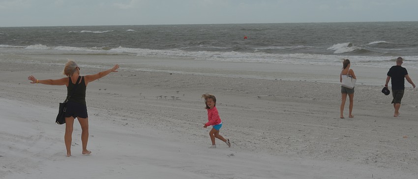 Hurricane Matthew's winds do not deter Longboat Key beachgoers in the early afternoon Friday. TERRY OCONNOR