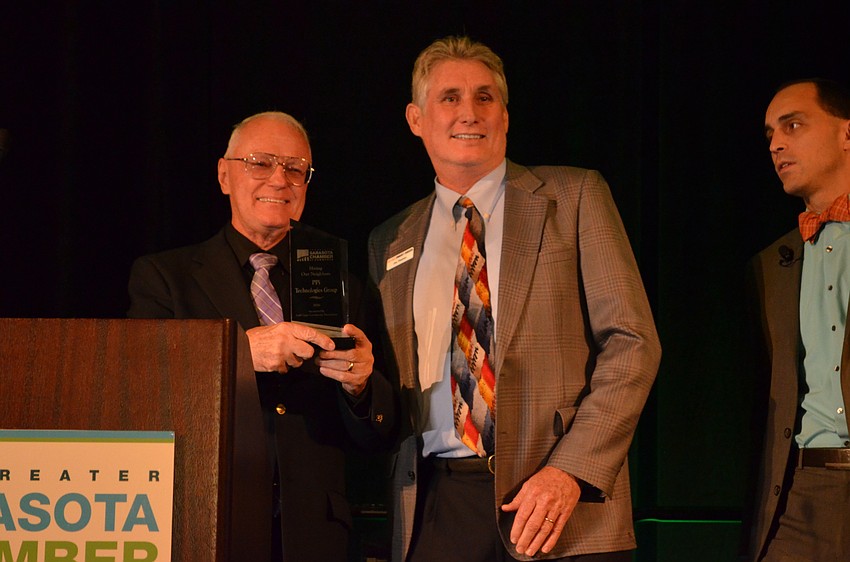 Charles Murray of PPi Technologies Group receiving the award for Hiring Our Neighbors from Jon Thaxton.
