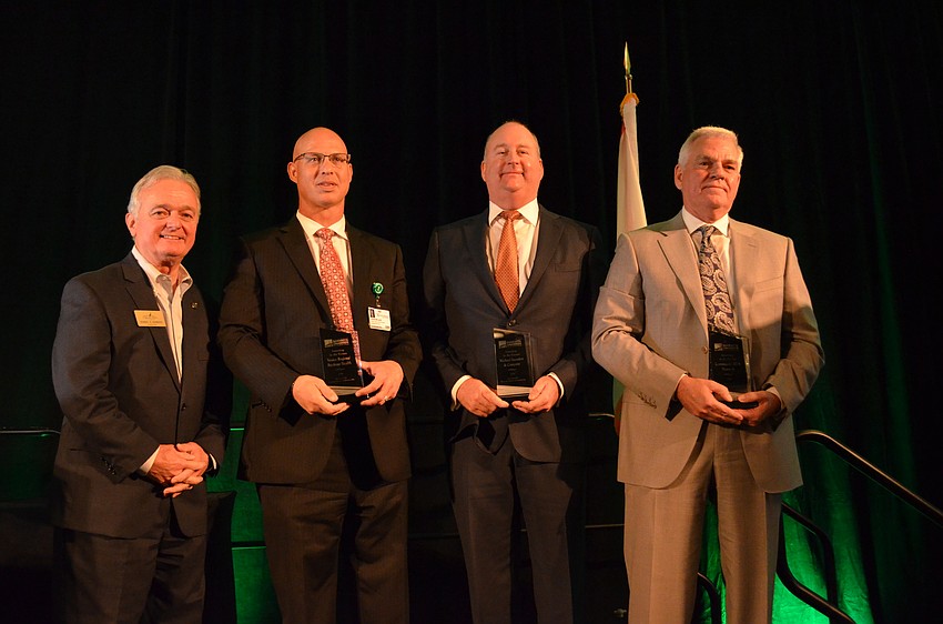 Plymouth Harbor President and CEO Harry Hobson presents the award for Investing for the Future to John McLain, Venice Regional Bayfront Health, Drayton Saunders, Michael Saunders and Company, and Richard Carlisle, Community Aids Network.