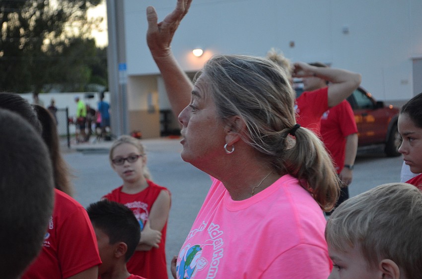 Wellness and Physical Education teacher Amy Kanter gives a pep talk to students before the start of the 7K and 1-Mile Fun Run.