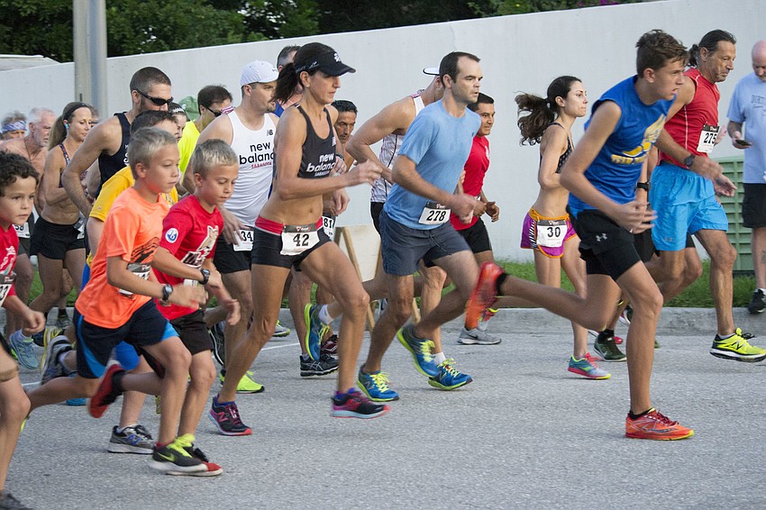 Runners take off on a new course for the start of the 8th annual Phillippi Shores 7K.