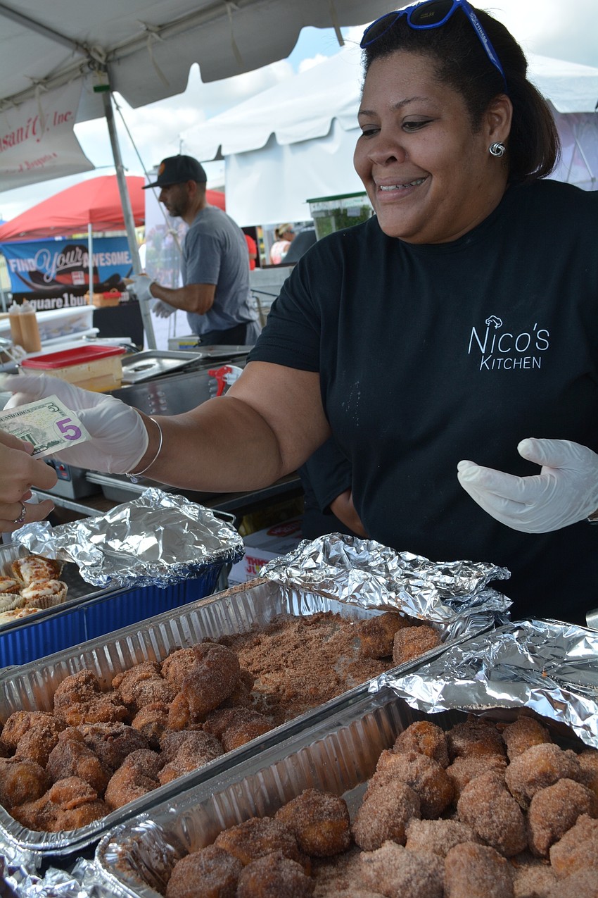 Anna Encarnacion serves up bacon-fried Oreos and other dishes from Nico's Kitchen.
