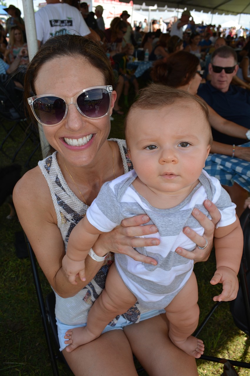 Rawley Ryckman, of Sarasota, finds a shady spot with her son, Tyler, 7 months.
