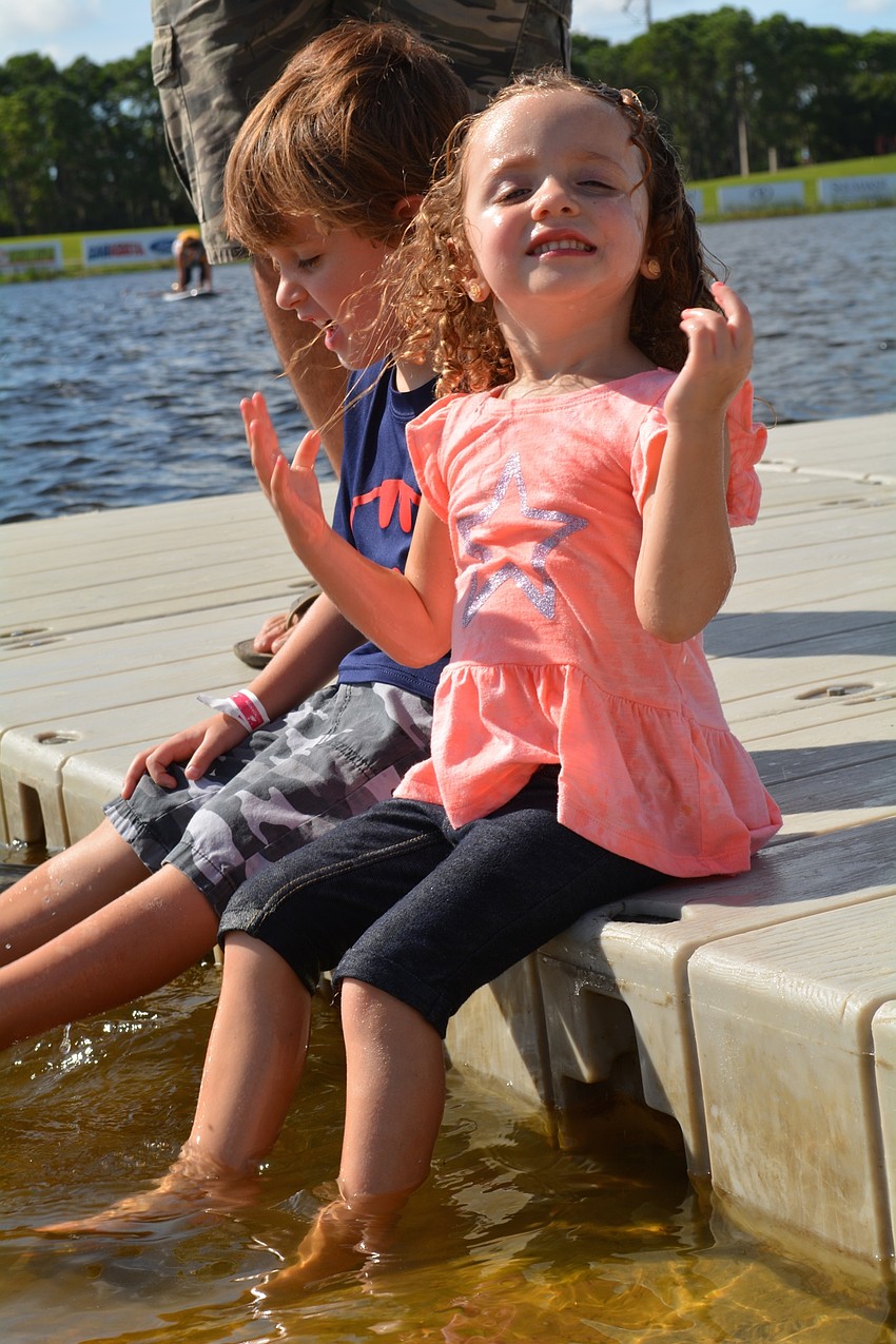 Marleigh Taylor, 2, of Sarasota, splashes in the lake with her brother, Drake.