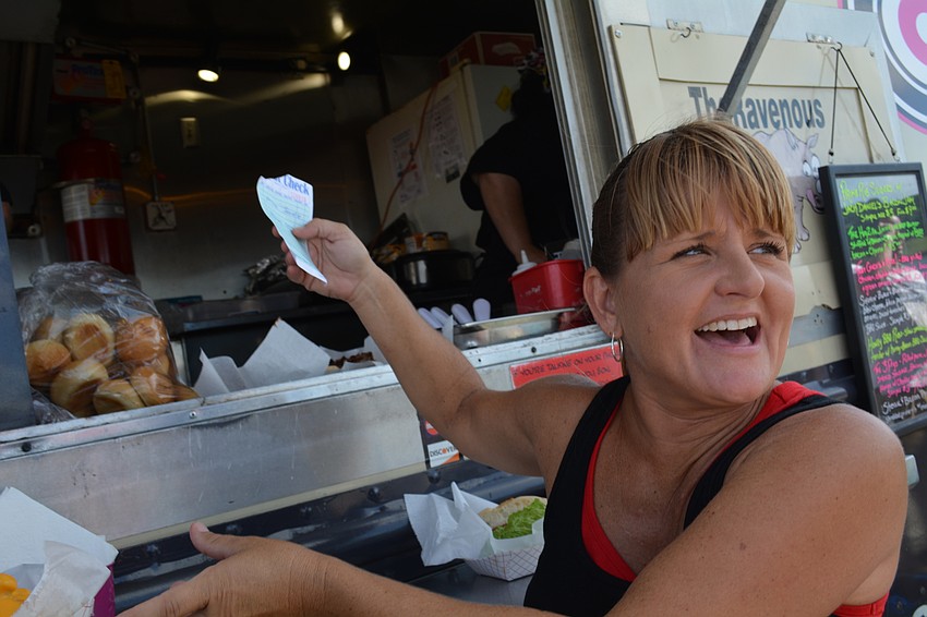 Shelley Morgan calls out and hands out orders to customers visiting The Ravenous Rhino.