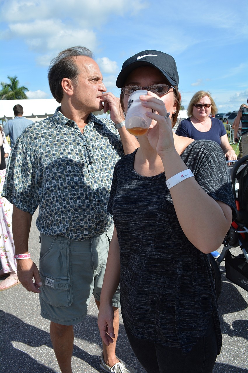 Alex Janotti, of Bradenton, samples a beer a friend brought for her.