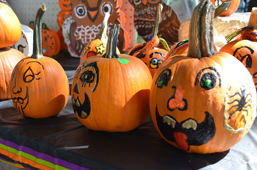Painted pumpkins sit in the sun to dry.