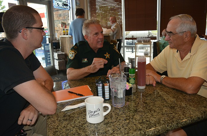 East County's Mike Lowe, Manatee County Sheriff's Office Capt. Bob Mealy and Tara's Bob Dallesandro visit during National Coffee with a Cop Day.