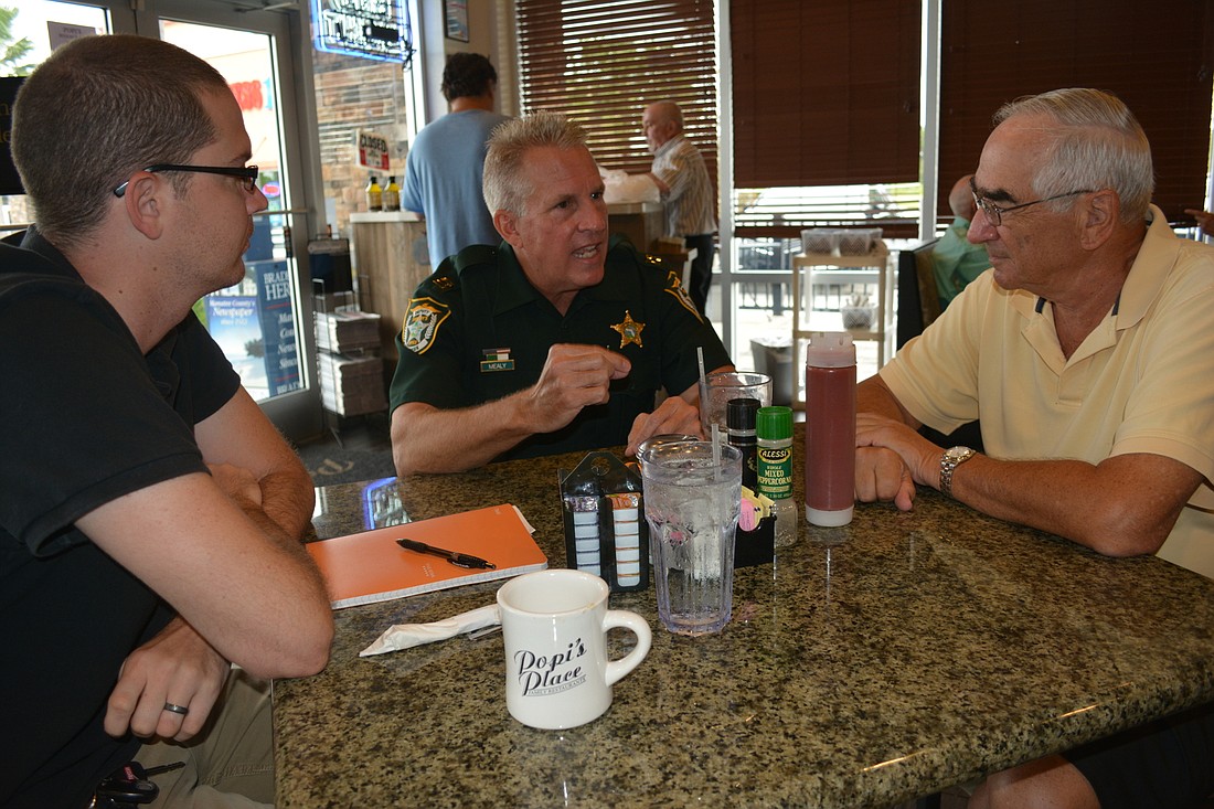 East County's Mike Lowe, Manatee County Sheriff's Office Capt. Bob Mealy and Tara's Bob Dallesandro visit during National Coffee with a Cop Day.