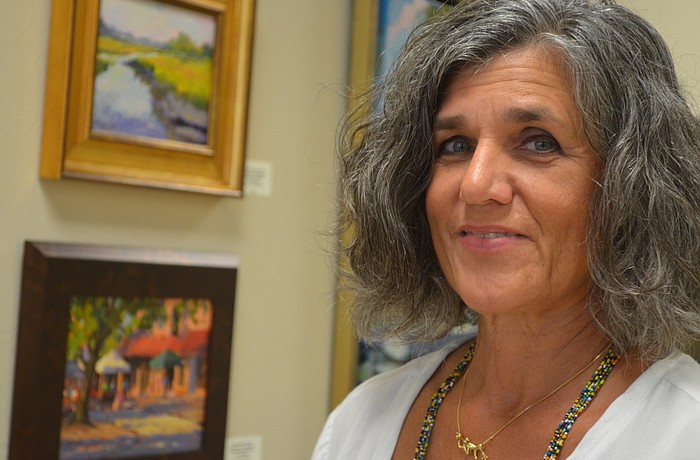 Katie Cundiff displays her art at Premier Sotheby's on Lakewood Main Street.
