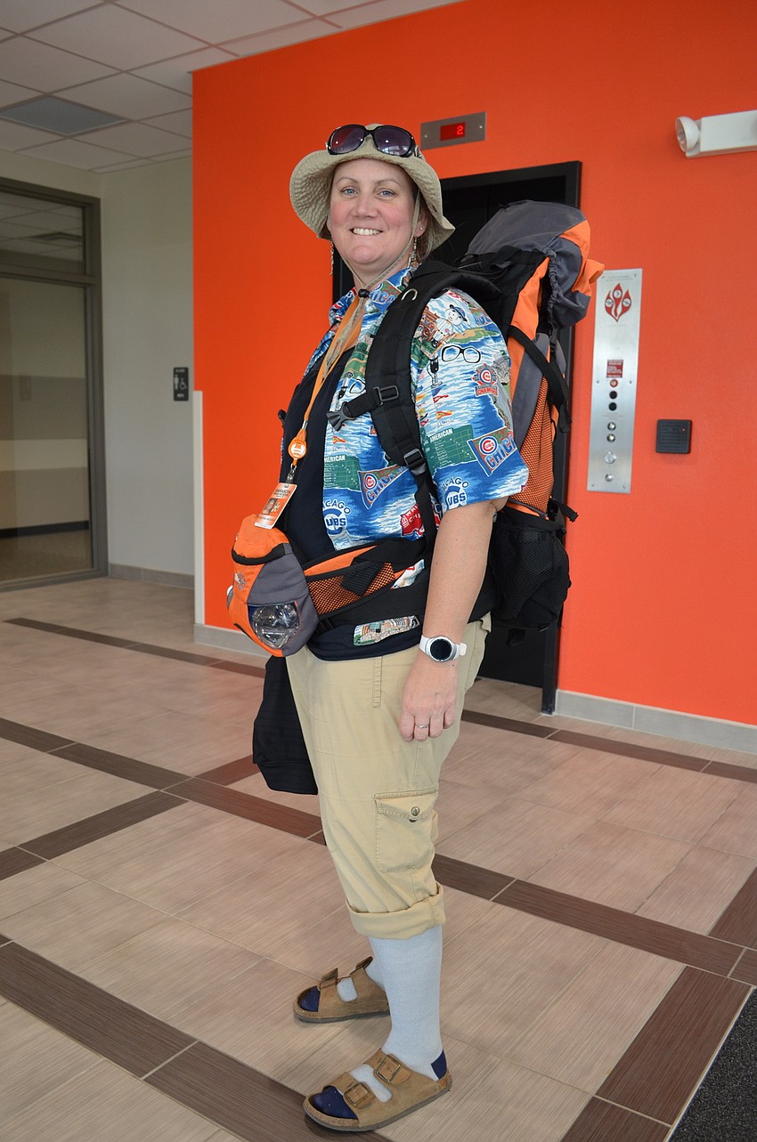 Math teacher Kris Weccele donned the same backpack that she actually used as a tourist during a trip to Europe.