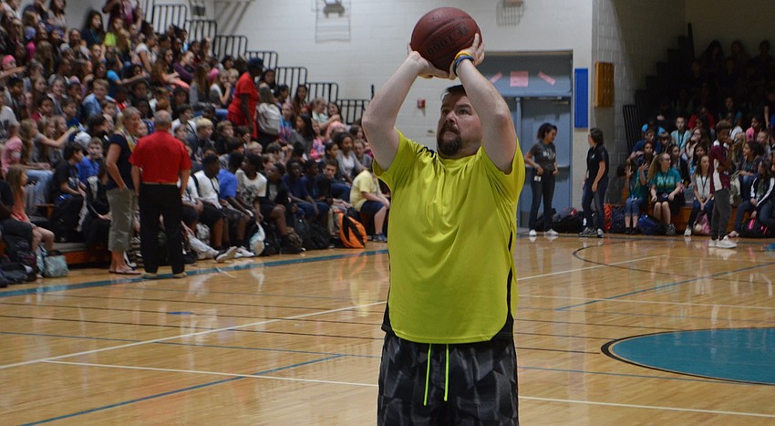 Chris King, a teacher at Haile Middle School, warms up before his free throw challenge.