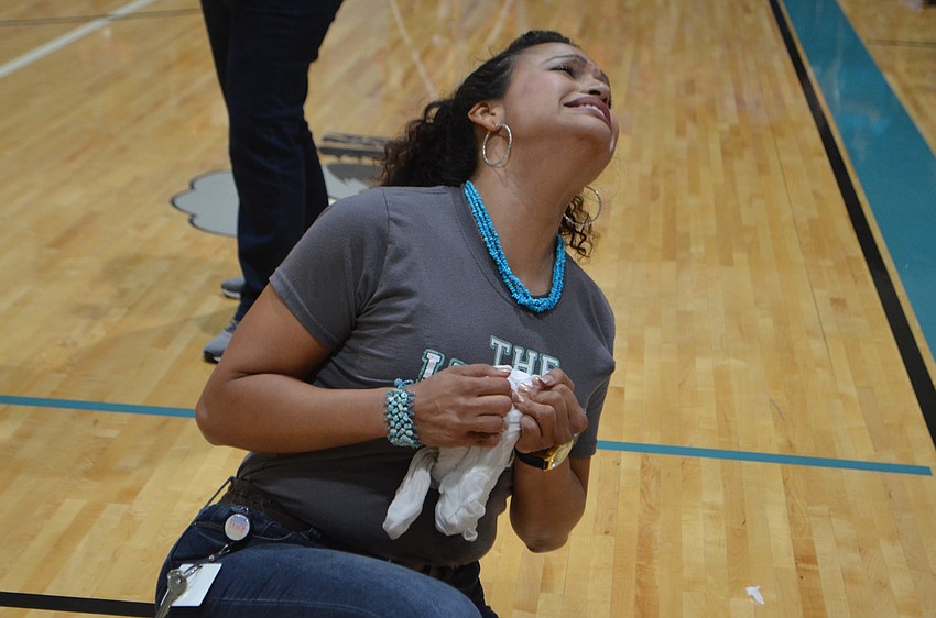 Teacher Olga Pena tries to pull the frozen T-shirt apart.