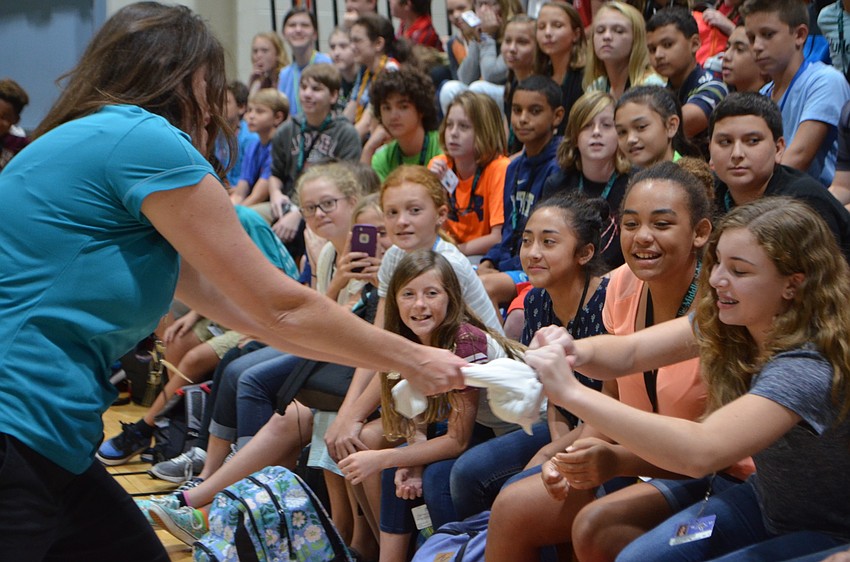 Math teacher Kristin Beck gets help student Ashlie Langlois as they try to pull apart a frozen T-shirt.