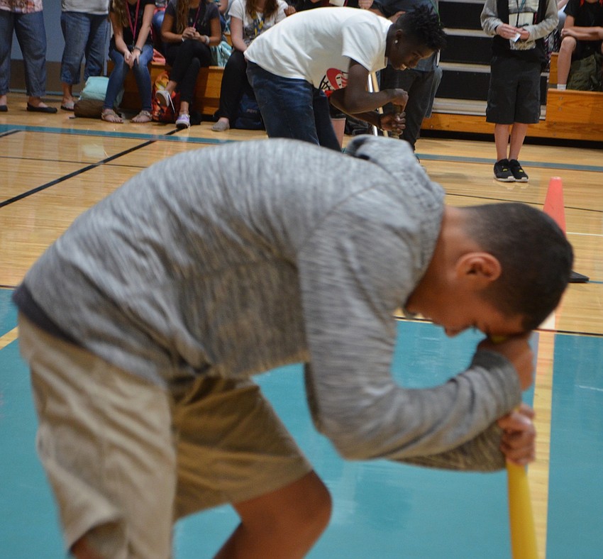 Student Jeremiah Keane spins 10 times before sprinting to the other side of the gym.
