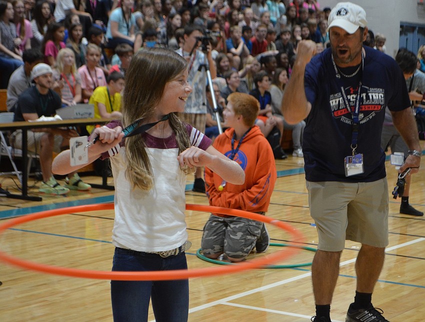 Physical education teacher Andrew Gugliemini cheers on sixth-grader Joslyn Chapman during the hula hoop competition.