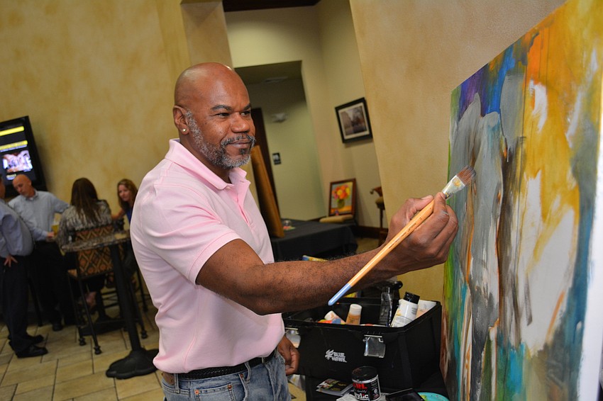 Artist Tom Ruthz paints live at the event so guests can see an artist in action. He likes to add splashes of color — influences from his native Brazil — to his work.